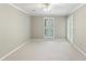 Spacious bedroom with neutral carpet and a window with plantation shutters at 23101 Plantation Ne Dr, Atlanta, GA 30324