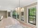 Dining room showcasing natural light, view of greenery, and a vintage chandelier at 23101 Plantation Ne Dr, Atlanta, GA 30324