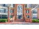 Brick exterior with large arched entry and stairs leads to the front doors of the homes at 23101 Plantation Ne Dr, Atlanta, GA 30324