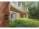 Charming brick building featuring a balcony and manicured landscaping at 23101 Plantation Ne Dr, Atlanta, GA 30324