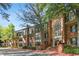 Brick building with a large arched entry and stairs, landscaping with lush trees and bushes at 23101 Plantation Ne Dr, Atlanta, GA 30324