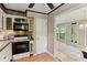 Open kitchen with modern appliances with view to dining room and screened porch at 23101 Plantation Ne Dr, Atlanta, GA 30324