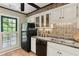 Updated kitchen with white cabinets, black appliances, and a view of the backyard at 23101 Plantation Ne Dr, Atlanta, GA 30324
