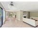 Spacious living room with fireplace and tile floors flowing seamlessly into the sunroom at 23101 Plantation Ne Dr, Atlanta, GA 30324