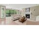 Living room featuring tile floors, a white sofa, and a cozy fireplace with a marble surround at 23101 Plantation Ne Dr, Atlanta, GA 30324