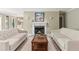 Living room with a marble fireplace, tile floors, white sofas and neutral wall color at 23101 Plantation Ne Dr, Atlanta, GA 30324