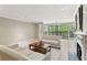 Bright living room showcasing a fireplace, tile flooring and large windows to outdoor space at 23101 Plantation Ne Dr, Atlanta, GA 30324