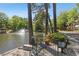 Scenic pond with a fountain and a bench, surrounded by lush trees and greenery at 23101 Plantation Ne Dr, Atlanta, GA 30324