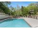 Community pool surrounded by trees and greenery at 23101 Plantation Ne Dr, Atlanta, GA 30324