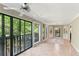 The sunroom has tile flooring and provides access to a balcony, along with multiple windows at 23101 Plantation Ne Dr, Atlanta, GA 30324