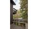 Exterior shot of the wooden deck and a wooded view featuring built-in benches and mature trees at 4727 Emily Sw Dr, Lilburn, GA 30047