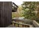 View from the wooden deck with built in benches that overlooks mature trees and landscaping at 4727 Emily Sw Dr, Lilburn, GA 30047