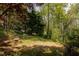 Enjoy lush greenery and mature trees from the backyard seating area at 4727 Emily Sw Dr, Lilburn, GA 30047
