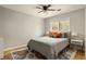 Bright bedroom with a ceiling fan, large window and a decorative area rug at 4727 Emily Sw Dr, Lilburn, GA 30047