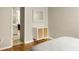Bedroom view showcasing a decorative cabinet and glimpse into an adjacent bathroom at 4727 Emily Sw Dr, Lilburn, GA 30047