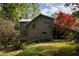 The exterior shows a well-maintained lawn, established garden beds, and mature trees surrounding the home at 4727 Emily Sw Dr, Lilburn, GA 30047
