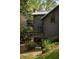 A close exterior view featuring balconies, a modern metal roof, and board and batten siding at 4727 Emily Sw Dr, Lilburn, GA 30047