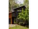 Exterior shot showcasing the unique wood siding and lovely landscaping that surrounds the home at 4727 Emily Sw Dr, Lilburn, GA 30047