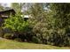 Beautiful house with wood siding surrounded by mature trees and lush landscaping at 4727 Emily Sw Dr, Lilburn, GA 30047