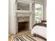 Close up of bedroom fireplace and mantle with brick surround and access to a private outdoor deck at 4727 Emily Sw Dr, Lilburn, GA 30047