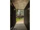 An outdoor hallway features rustic board and batten siding and a view of the front yard at 4727 Emily Sw Dr, Lilburn, GA 30047