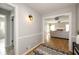 Hallway with decorative rug, lighting, and doorways to other rooms at 4727 Emily Sw Dr, Lilburn, GA 30047