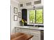 The kitchen boasts a large window, white cabinets, and stylish black backsplash at 4727 Emily Sw Dr, Lilburn, GA 30047