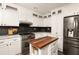 The kitchen features white cabinets, stainless steel appliances, and a contrasting dark backsplash at 4727 Emily Sw Dr, Lilburn, GA 30047