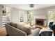 Comfortable living room with brick fireplace, stylish decor, and access to the backyard at 4727 Emily Sw Dr, Lilburn, GA 30047