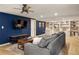 Finished basement living room boasts a large tv, built-in shelves and stylish furnishings at 4727 Emily Sw Dr, Lilburn, GA 30047