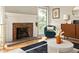 Bright and airy living room with a fireplace, hardwood floors, and modern decor at 4727 Emily Sw Dr, Lilburn, GA 30047
