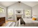 Bright main bedroom featuring a fireplace, vaulted ceilings, and access to a private outdoor deck at 4727 Emily Sw Dr, Lilburn, GA 30047