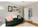 Comfortable office area adjacent to a bathroom with a stylish green couch and artwork at 4727 Emily Sw Dr, Lilburn, GA 30047
