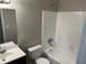 Clean bathroom with white tiled shower/tub and vanity with sink at 6334 Forester Way, Lithonia, GA 30038