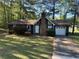 Charming single-story home featuring a brick chimney and well-maintained front yard with mature trees at 6334 Forester Way, Lithonia, GA 30038