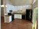 Functional kitchen with white cabinets, granite-look countertops, and black appliances at 6334 Forester Way, Lithonia, GA 30038