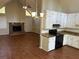 Open living room and kitchen area with a brick fireplace, modern appliances, and wood-look flooring at 6334 Forester Way, Lithonia, GA 30038