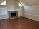 Cozy living room featuring a brick fireplace, wood-look flooring, and ample natural light at 6334 Forester Way, Lithonia, GA 30038