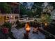 Beautiful backyard featuring a fire pit with seating, mature landscaping, and a screened-in porch at 844 Nob Ridge Dr, Marietta, GA 30064