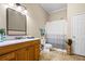 Bathroom with wood vanity, decorative mirror, and bathtub/shower combination at 844 Nob Ridge Dr, Marietta, GA 30064