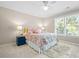 Bright bedroom featuring a bed with a colorful comforter and large window at 844 Nob Ridge Dr, Marietta, GA 30064