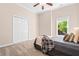 This cozy bedroom is a peaceful retreat with plush carpet, a ceiling fan, and natural light from the window at 844 Nob Ridge Dr, Marietta, GA 30064