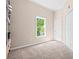 A clean bedroom featuring neutral walls, carpet, a window, and closet space, perfect for rest and relaxation at 844 Nob Ridge Dr, Marietta, GA 30064