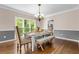 Beautiful dining room featuring hardwood floors, decorative chandelier, and natural light streaming through large windows at 844 Nob Ridge Dr, Marietta, GA 30064