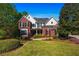 Traditional brick home with lush landscaping and a well-manicured lawn, offering curb appeal at 844 Nob Ridge Dr, Marietta, GA 30064