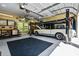Spacious garage featuring a car lift, storage cabinets, and workspace, perfect for car enthusiasts at 844 Nob Ridge Dr, Marietta, GA 30064