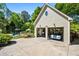 Detached two-car garage with lift, storage, and adjacent pool and patio area at 844 Nob Ridge Dr, Marietta, GA 30064