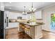 Beautiful kitchen boasts white cabinets, a large island, granite countertops and stainless steel appliances at 844 Nob Ridge Dr, Marietta, GA 30064