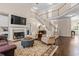A living room with a fireplace, hardwood flooring, a cozy arrangement of seating, and staircase to upper level at 844 Nob Ridge Dr, Marietta, GA 30064