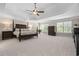 Spacious primary bedroom featuring a tray ceiling, ceiling fan, and large windows at 844 Nob Ridge Dr, Marietta, GA 30064